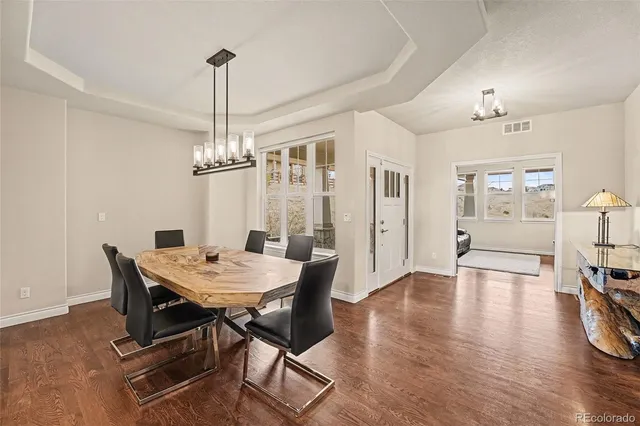 a view of a dining room with furniture wooden floor and chandelier