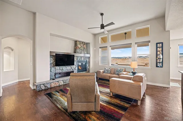 a living room with furniture a flat screen tv and a table