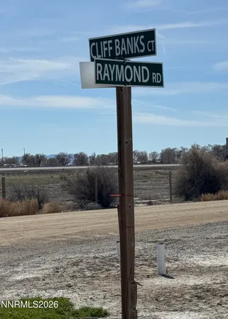 a street sign on a wall next to a road