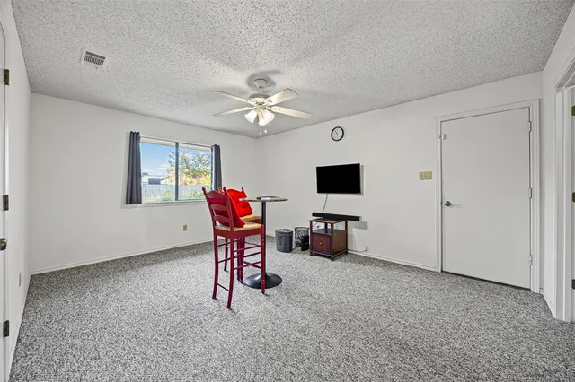 a view of a livingroom with furniture and a flat screen tv