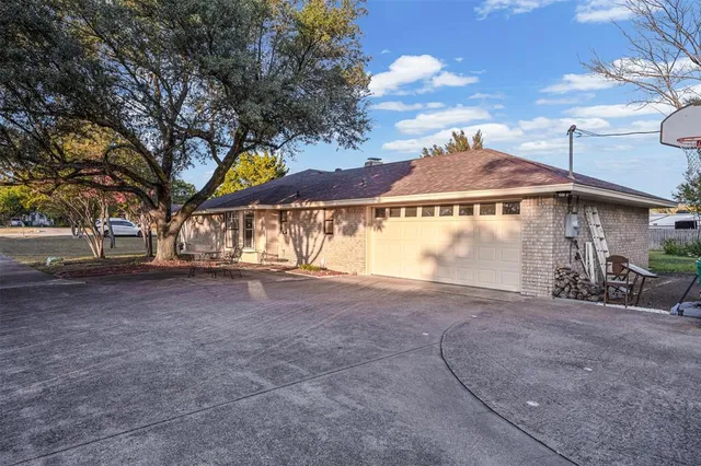 a view of a house with a large tree and a tree