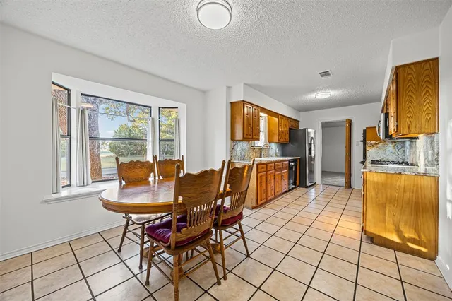a view of a dining room with furniture and a window