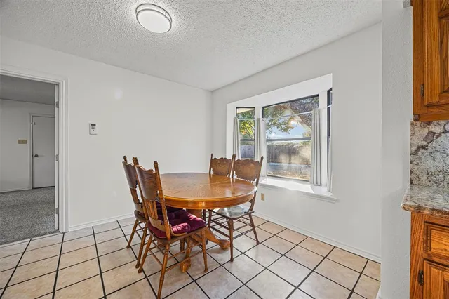 a view of a dining room with furniture and a window