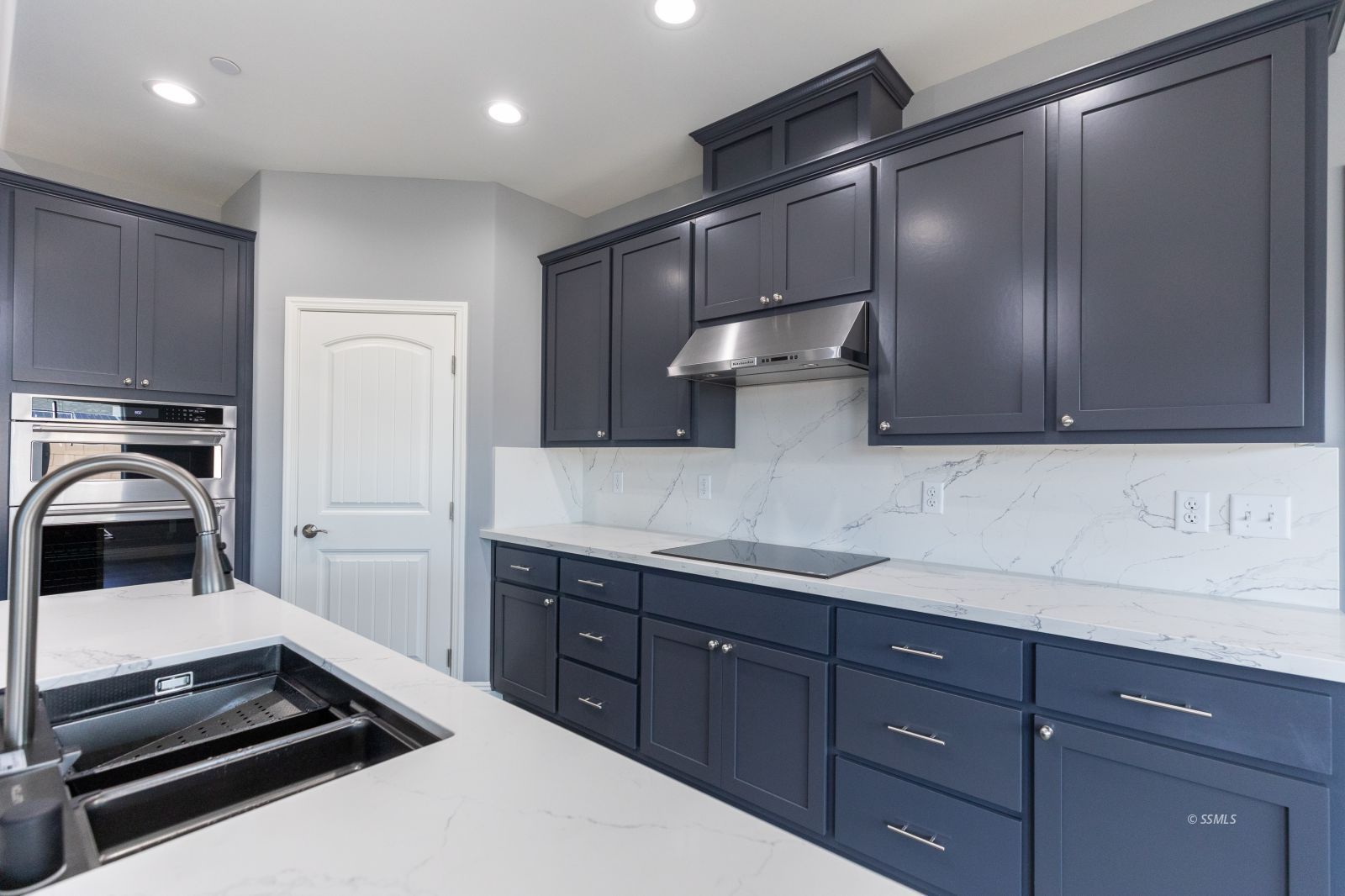 424 Thomas Street Ridgecrest, CA 93555 - Photo 11 of 30 a kitchen with a sink and wooden cabinets