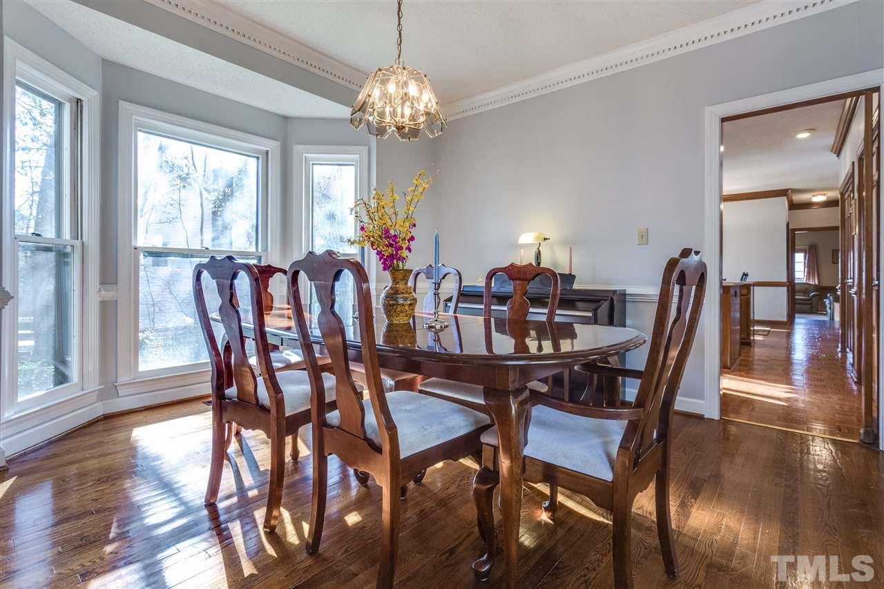 8108 Mourning Dove Road Raleigh, NC 27615 - Photo 12 of 25 a view of a dining room with furniture window and wooden floor