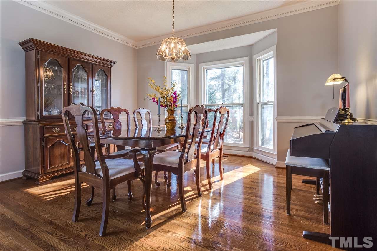 8108 Mourning Dove Road Raleigh, NC 27615 - Photo 13 of 25 a view of a dining room with furniture window and wooden floor