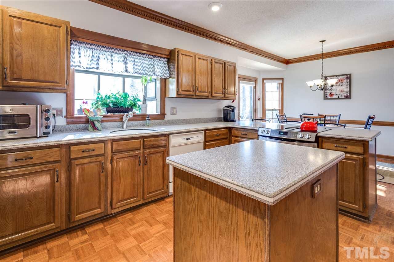 8108 Mourning Dove Road Raleigh, NC 27615 - Photo 15 of 25 a kitchen with sink cabinets and dining table