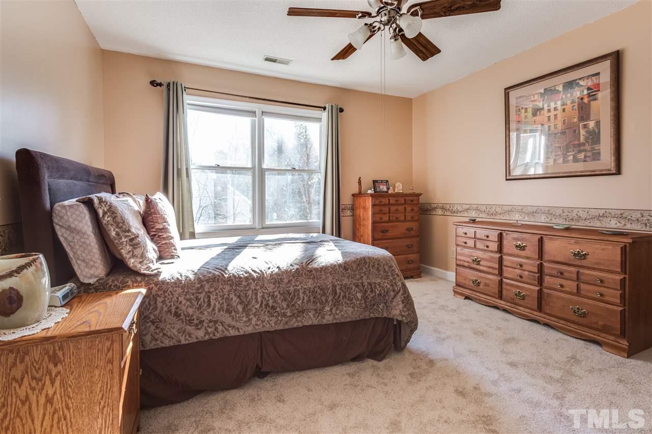 8108 Mourning Dove Road Raleigh, NC 27615 - Photo 19 of 25 a bedroom with a bed dresser and wooden floor