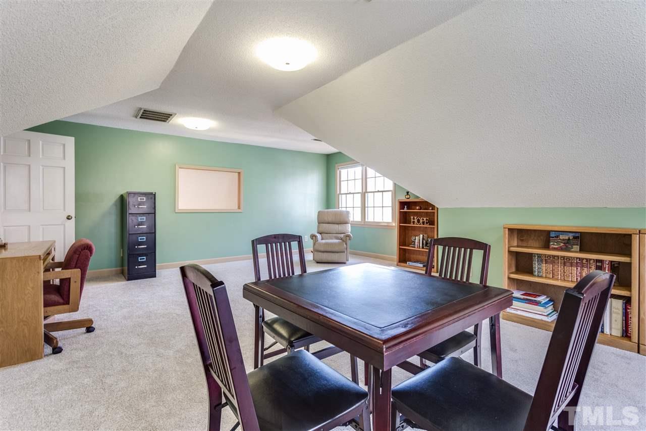 8108 Mourning Dove Road Raleigh, NC 27615 - Photo 22 of 25 a view of a dining room with furniture and a bookshelf