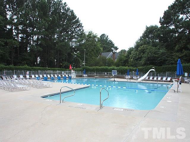8108 Mourning Dove Road Raleigh, NC 27615 - Photo 25 of 25 a view of a swimming pool with a table and chairs in the patio