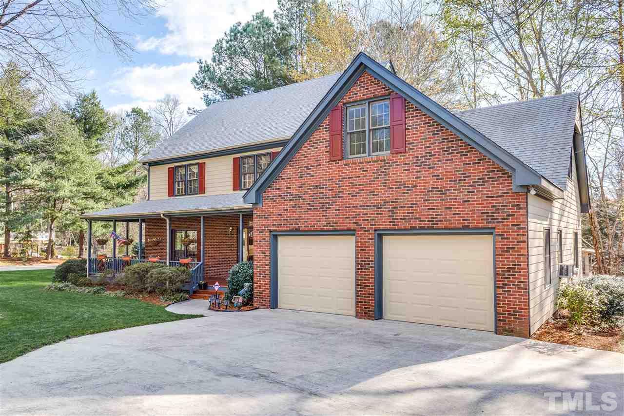 8108 Mourning Dove Road Raleigh, NC 27615 - Photo 5 of 25 a front view of a house with a yard and garage