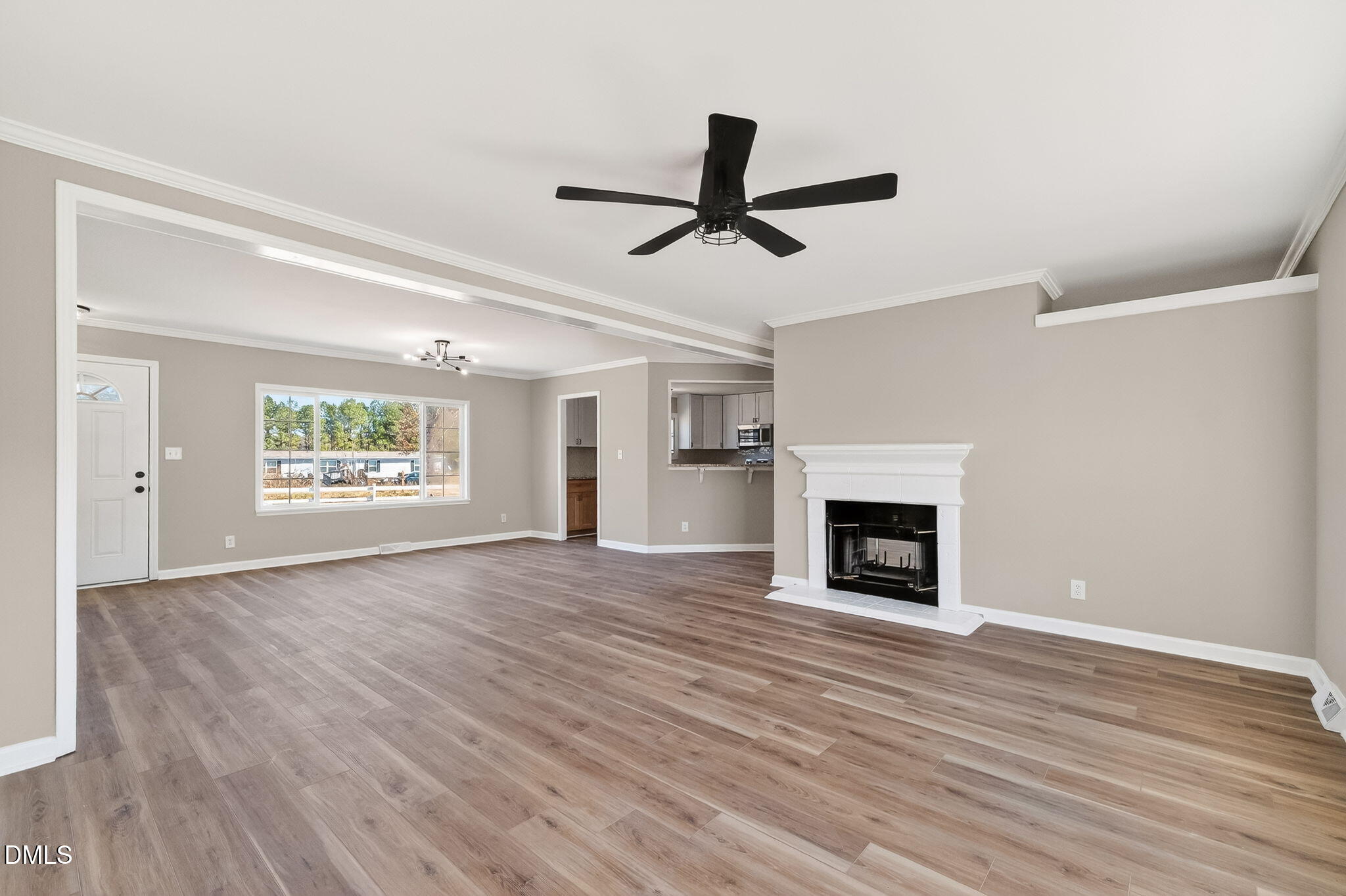 10015 Smith Road Middlesex, NC 27557 - Photo 12 of 48 an empty room with windows fireplace and wooden floor