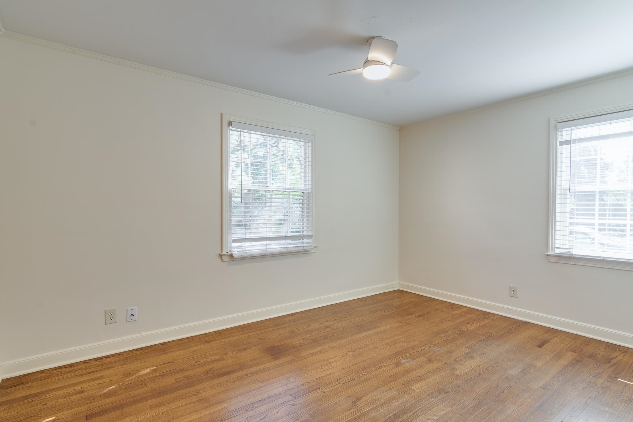 695 Berry Road Memphis, TN 38117 - Photo 12 of 32 an empty room with wooden floor and windows