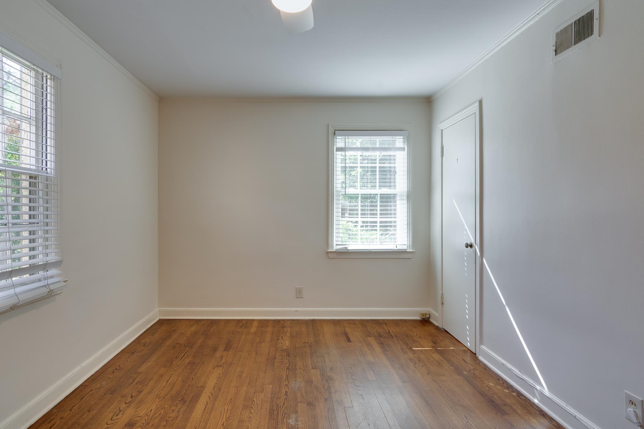 695 Berry Road Memphis, TN 38117 - Photo 13 of 32 an empty room with wooden floor and windows