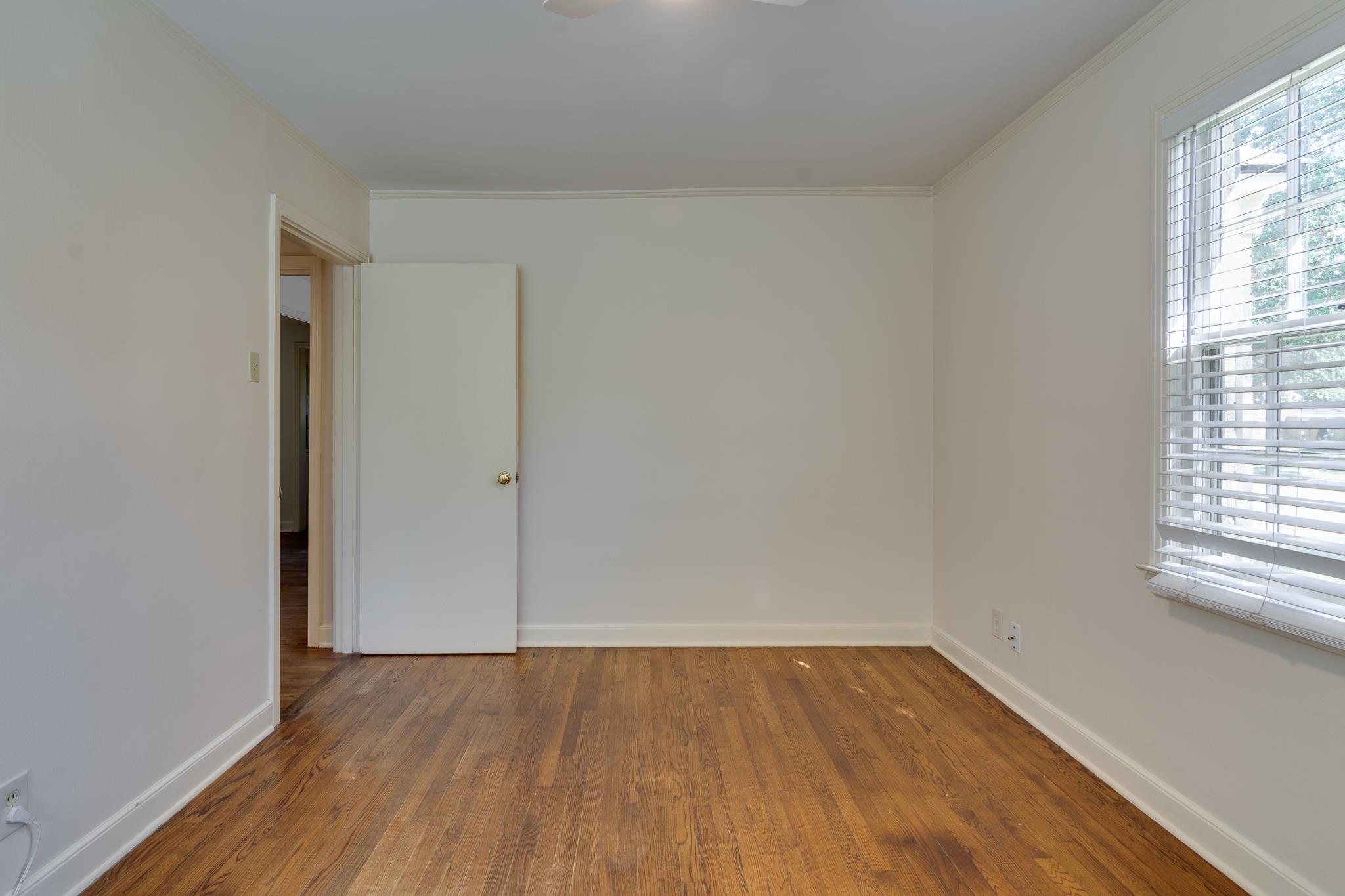 695 Berry Road Memphis, TN 38117 - Photo 14 of 32 an empty room with wooden floor and windows