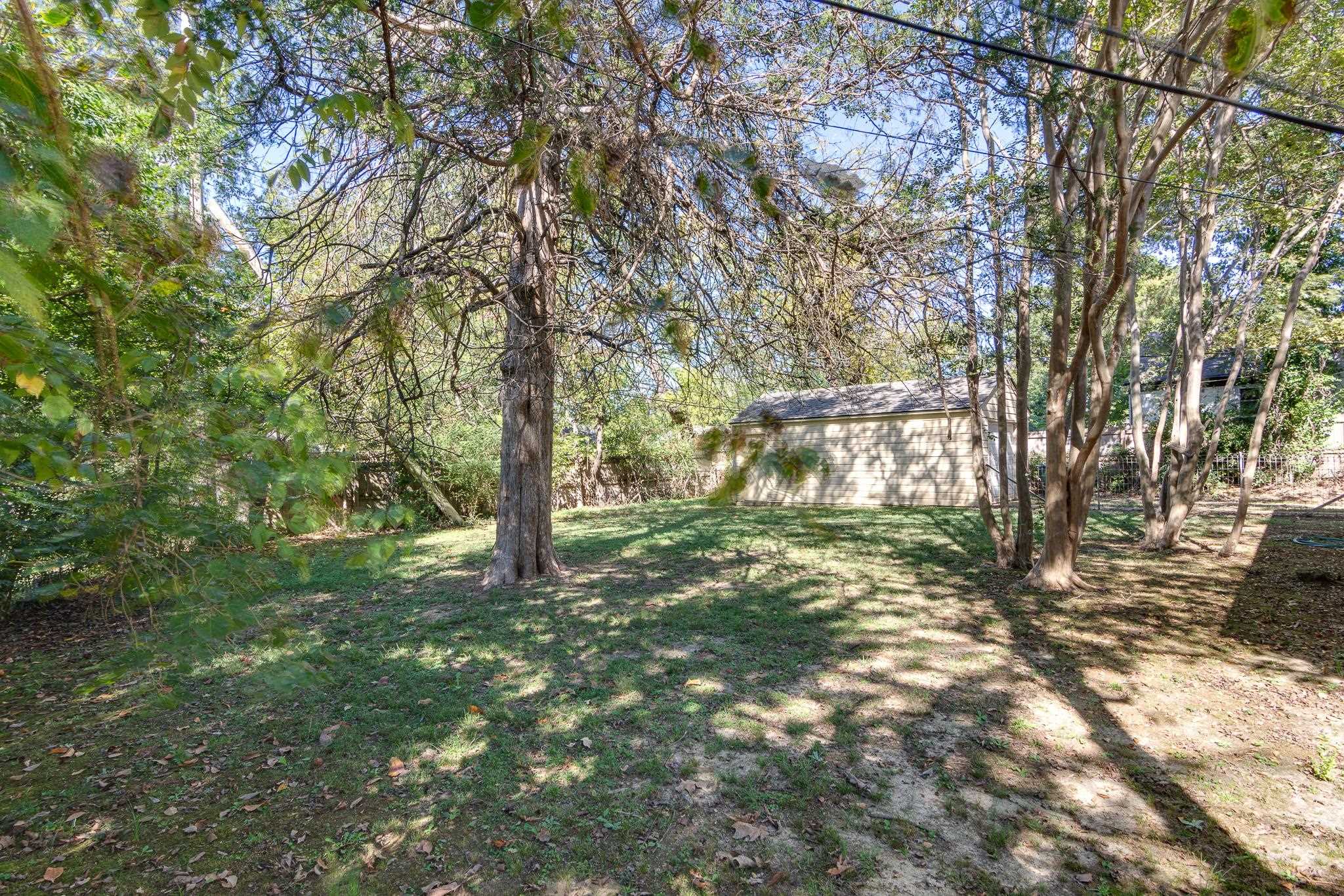 695 Berry Road Memphis, TN 38117 - Photo 22 of 32 a big yard with lots of green space and house in the back
