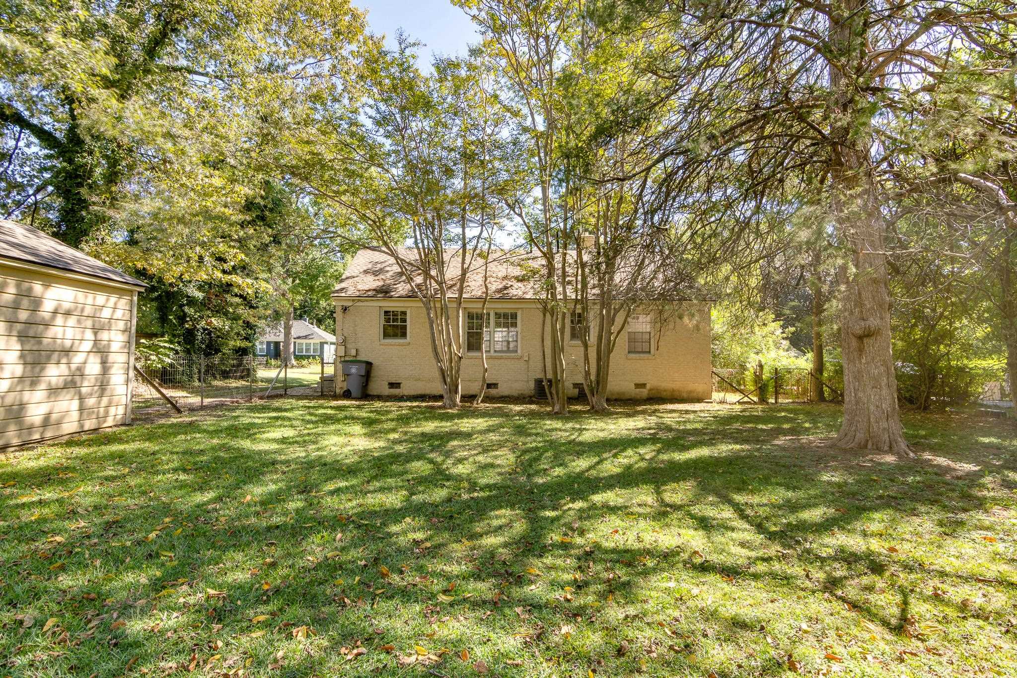 695 Berry Road Memphis, TN 38117 - Photo 23 of 32 a big house with trees in front of it