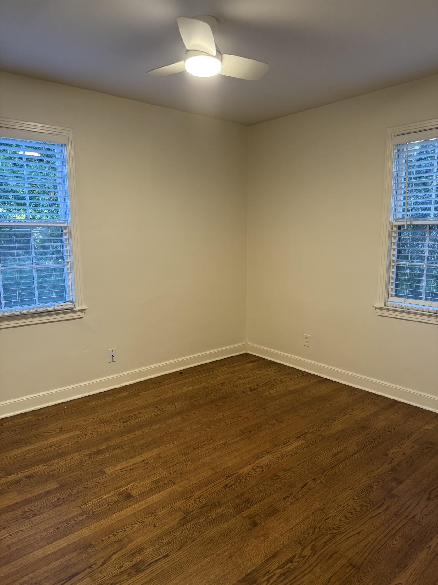 695 Berry Road Memphis, TN 38117 - Photo 26 of 32 a view of an empty room with wooden floor and a window