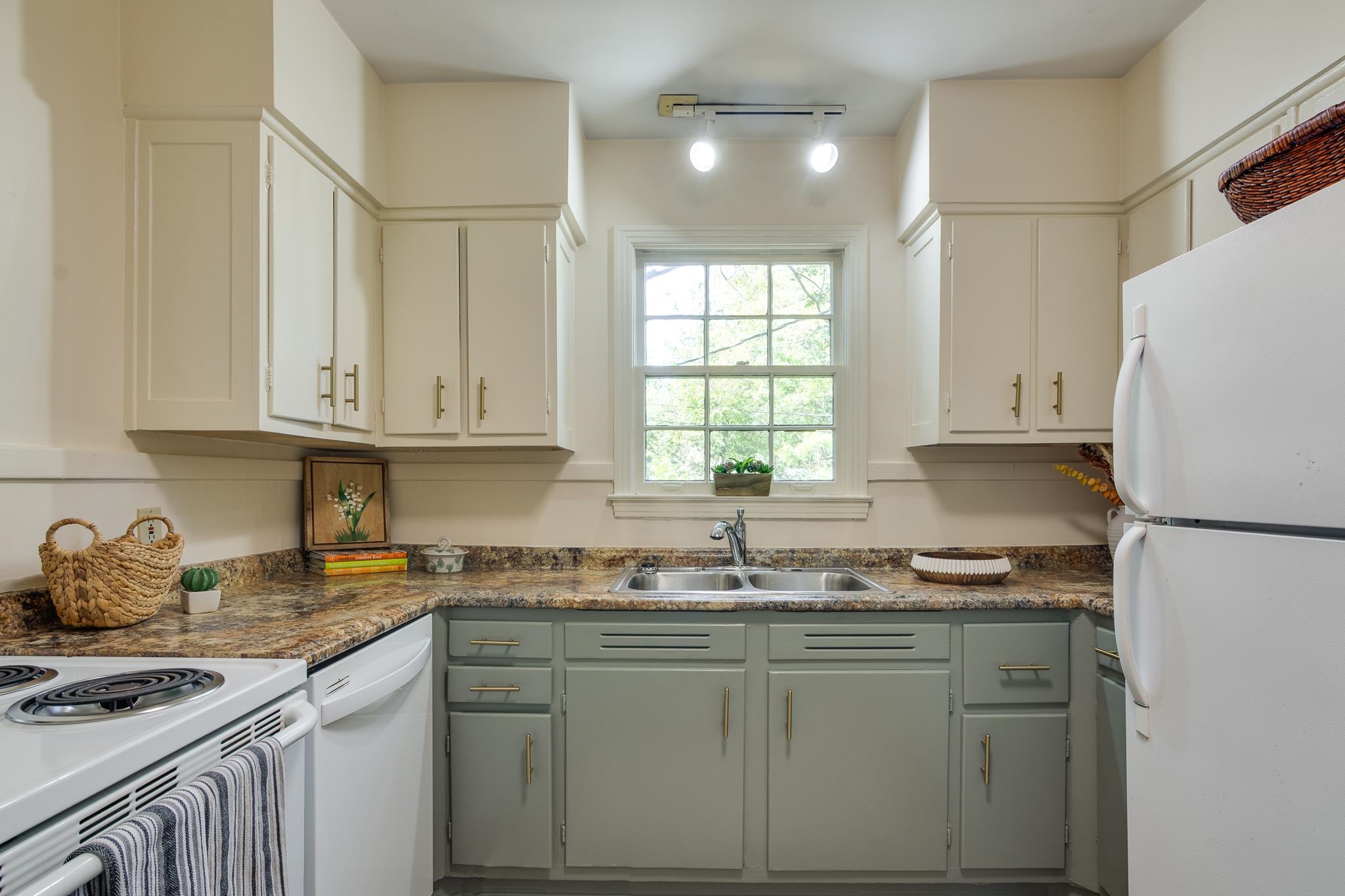695 Berry Road Memphis, TN 38117 - Photo 10 of 32 a kitchen with granite countertop a sink cabinets stainless steel appliances and a window