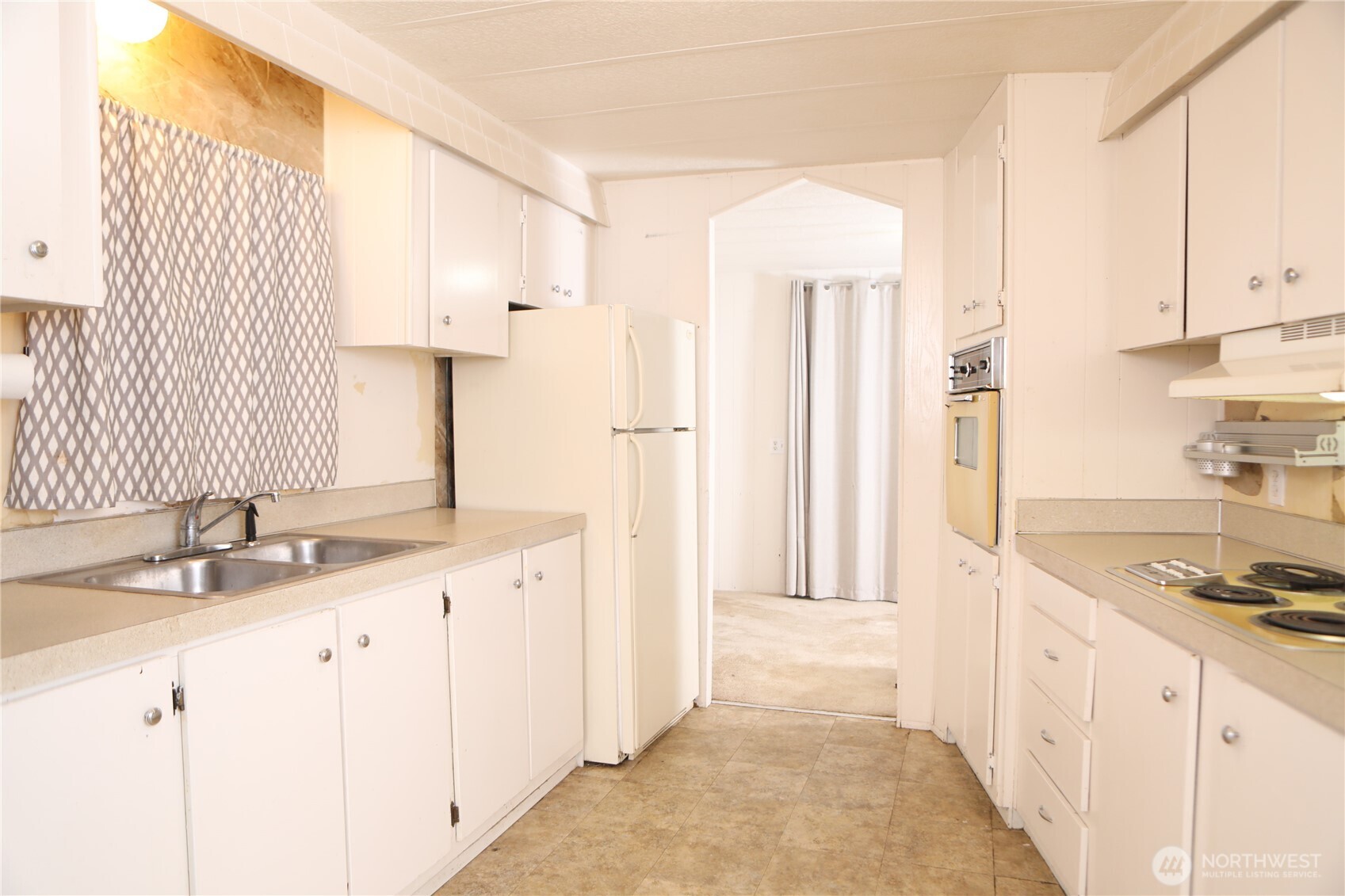 410 Totem Pole Road Manson, WA 98831 - Photo 14 of 27 a kitchen with granite countertop a sink stove and cabinets