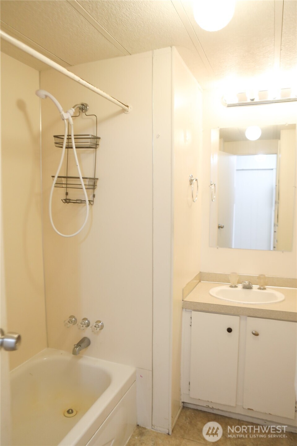 410 Totem Pole Road Manson, WA 98831 - Photo 23 of 27 a bathroom with a granite countertop sink a mirror and shower