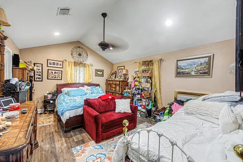 a bedroom with furniture and a chandelier