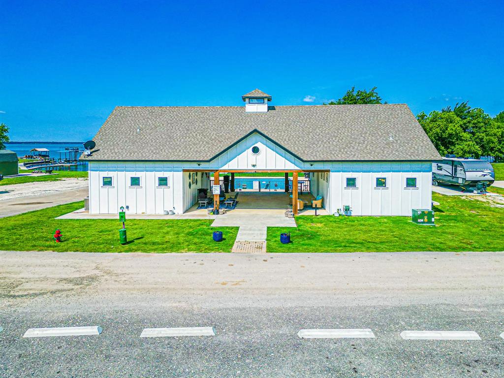 Lot 118 Peninsula Road Kerens, TX 75144 - Photo 23 of 37 a view of house with a yard and potted plants