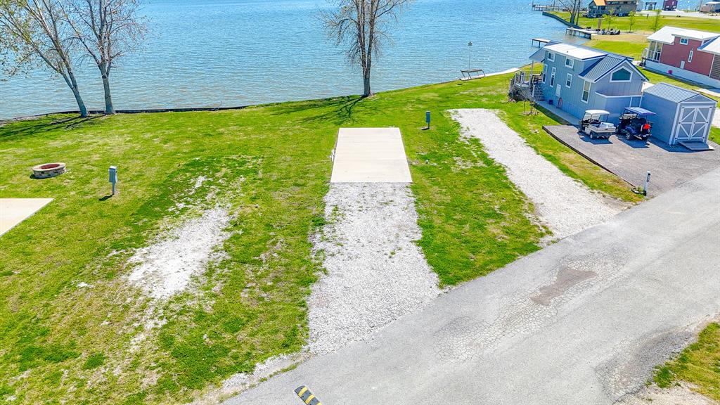 Lot 118 Peninsula Road Kerens, TX 75144 - Photo 5 of 37 a backyard of a house with lots of green space