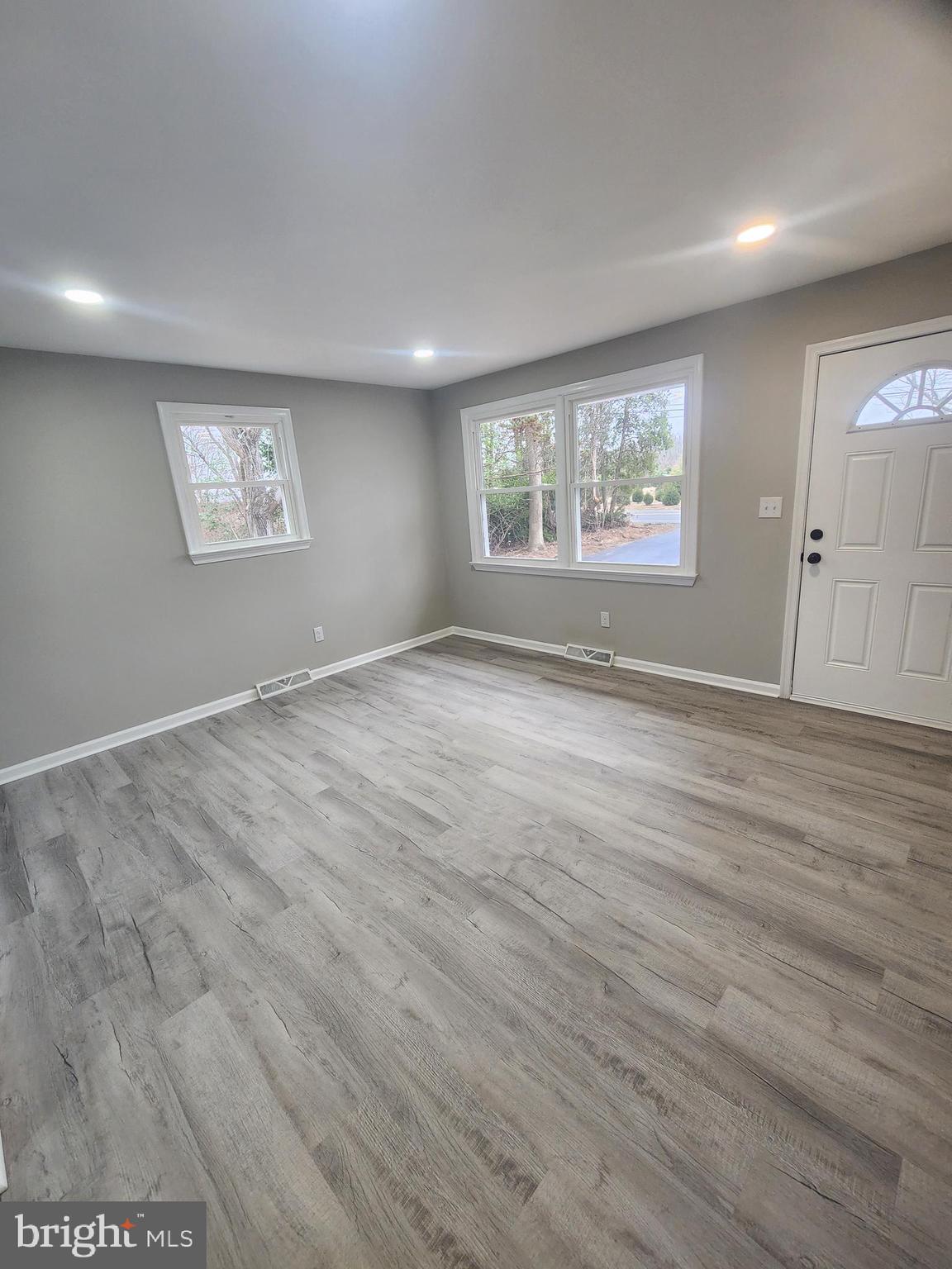496 Big Oak Road Bridgeton, NJ 08302 - Photo 7 of 31 an empty room with wooden floor and windows
