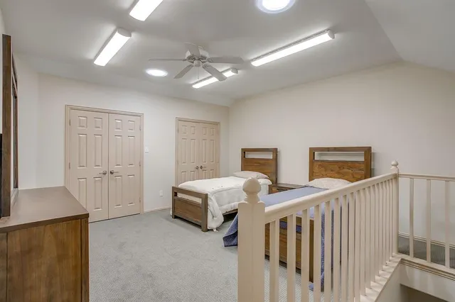 a bedroom with three beds and a chandelier