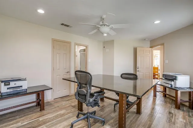 a view of a workspace with furniture and wooden floor