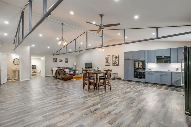 a view of a room with furniture and wooden floor