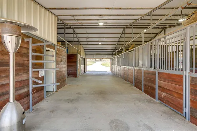 a view of an empty room with wooden shelves