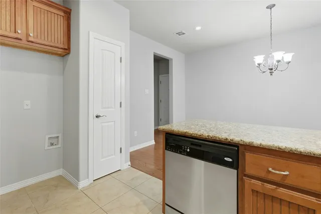 a view of a kitchen with granite countertop cabinets