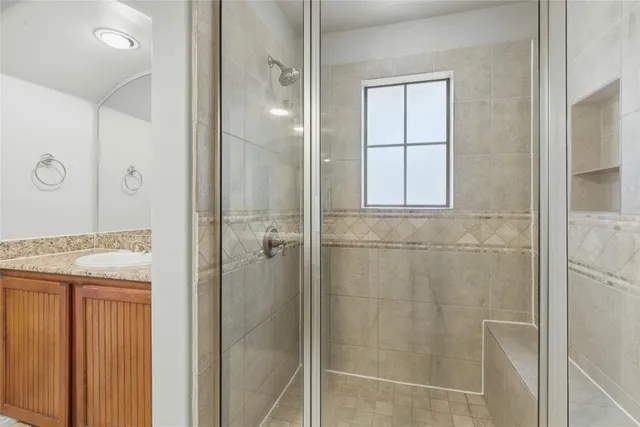 a bathroom with a shower and a sink