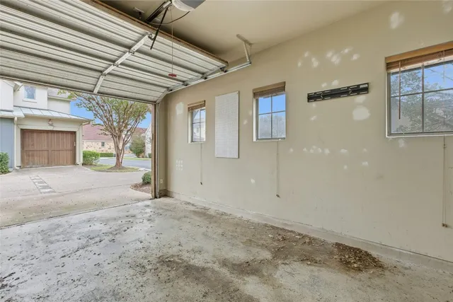 a view of a hallway with wooden floor and chandelier