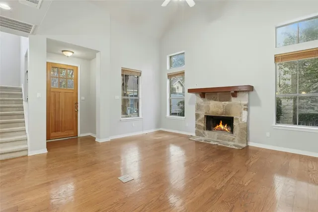 a view of empty room with a fireplace and window