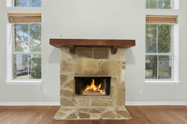 a living room with a fireplace and a window