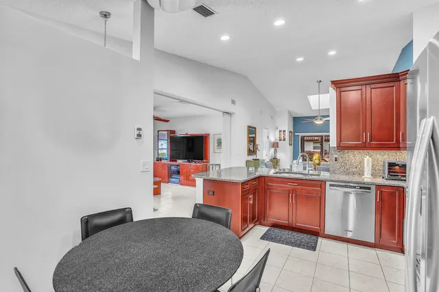 a kitchen with stainless steel appliances granite countertop a sink stove and cabinets
