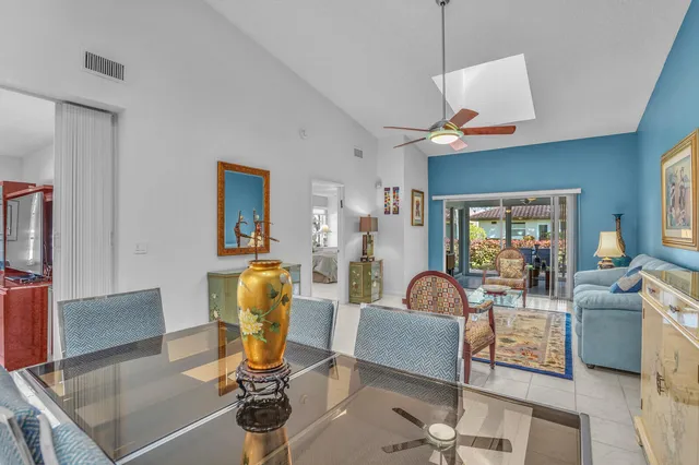 a view of a dining room with furniture a rug and wooden floor