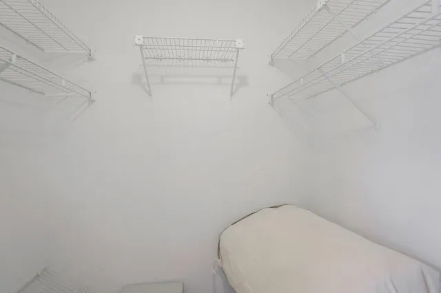 a bathroom with a granite countertop sink mirror and toilet