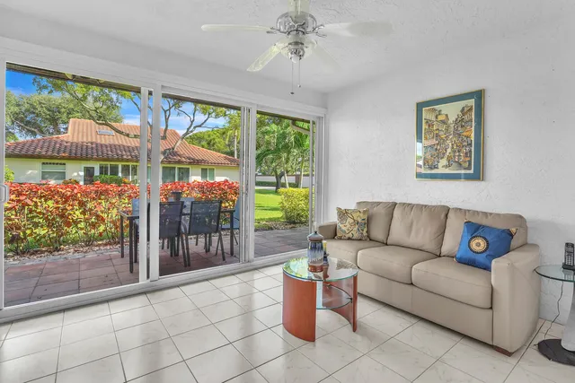 a living room with furniture and a floor to ceiling window