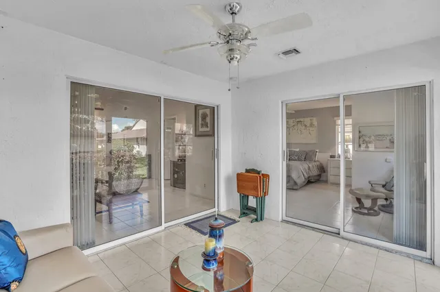 a living room with furniture and a glass door shower