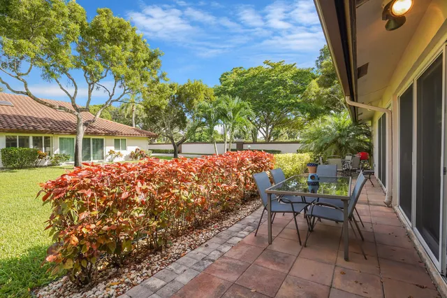 a view of a patio with table and chairs and potted plants
