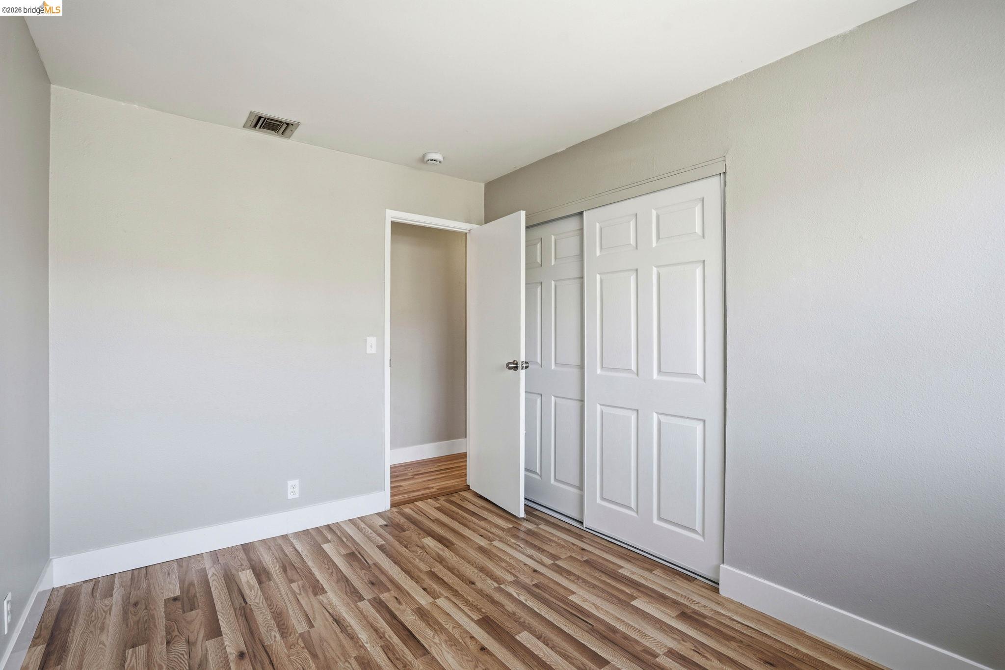 840 Key Rte Boulevard Albany, CA 94706 - Photo 26 of 43 Unfurnished bedroom featuring light wood-type flooring and a closet