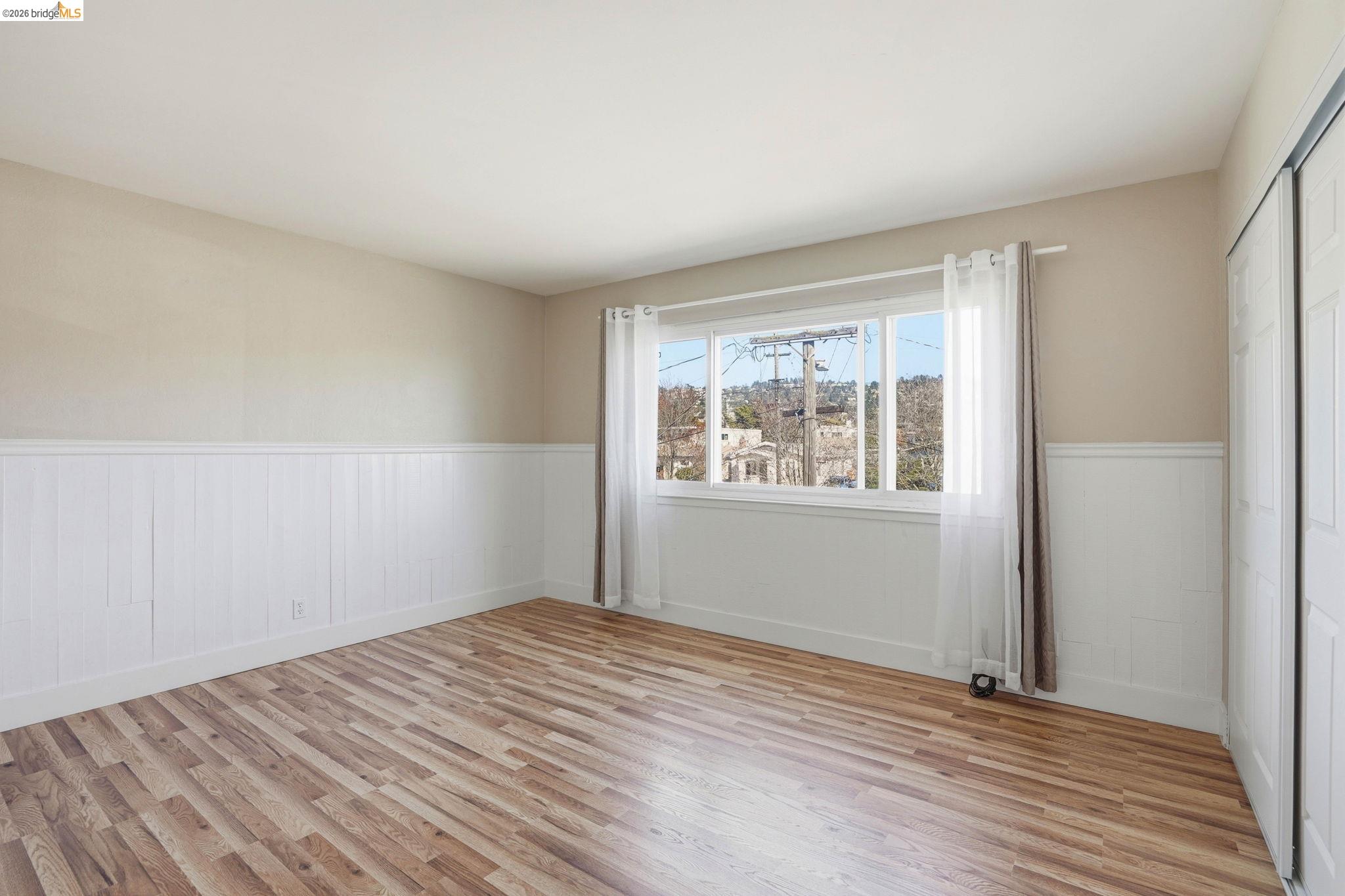 840 Key Rte Boulevard Albany, CA 94706 - Photo 27 of 43 Unfurnished room with light wood finished floors and wainscoting
