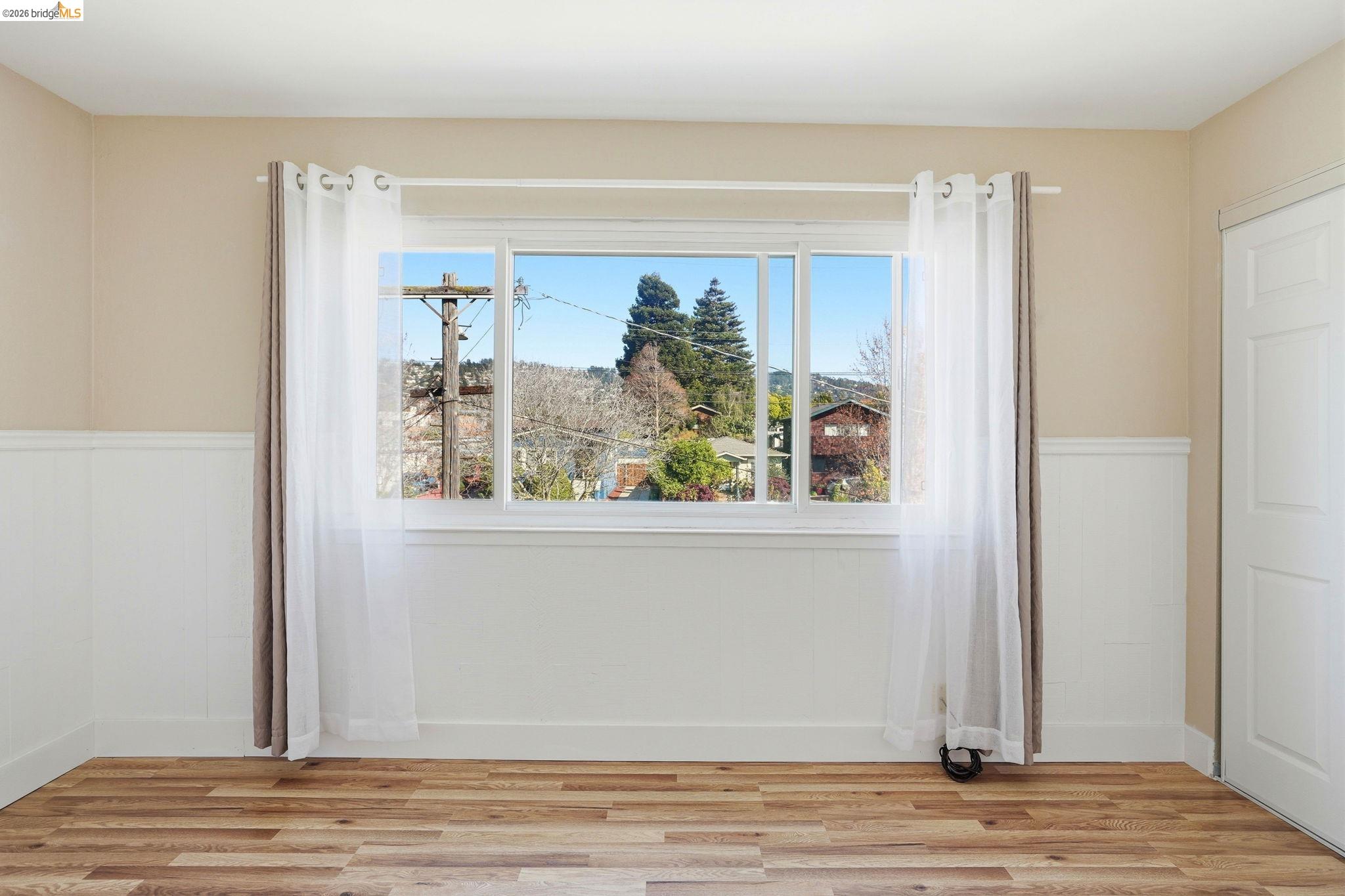 840 Key Rte Boulevard Albany, CA 94706 - Photo 29 of 43 Unfurnished room with wainscoting and light wood-type flooring