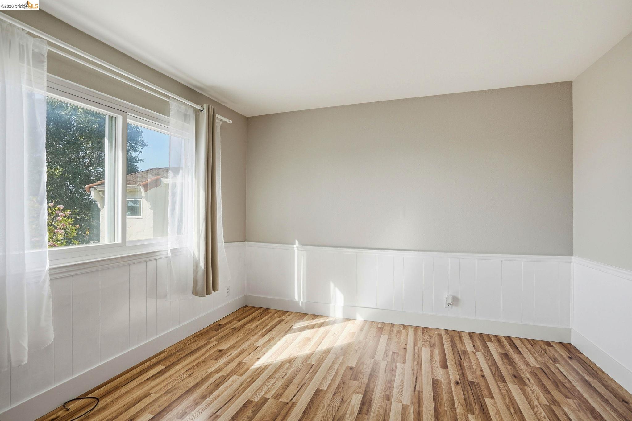 840 Key Rte Boulevard Albany, CA 94706 - Photo 30 of 43 Spare room with light wood-style flooring and wainscoting