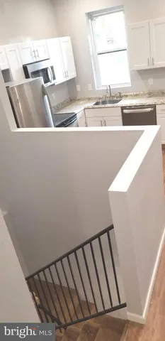 a view of a kitchen with sink and dishwasher