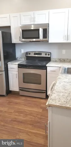 a kitchen with granite countertop a stove and a sink